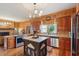 This kitchen boasts wood cabinetry, granite countertops, stainless appliances, and a decorative chandelier at 1068 Witherbee Rd, Moncks Corner, SC 29461