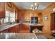 Spacious kitchen with granite countertops, wood cabinetry, stainless appliances and decorative chandelier at 1068 Witherbee Rd, Moncks Corner, SC 29461
