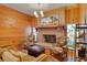 Bright living room with brick fireplace, wood paneled walls, decorative art and sitting area at 1068 Witherbee Rd, Moncks Corner, SC 29461