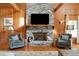 Cozy seating area featuring stone fireplace and stylish decor at 1068 Witherbee Rd, Moncks Corner, SC 29461