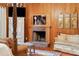 Close up of the living space of the main bedroom with fireplace, seating, and art at 1068 Witherbee Rd, Moncks Corner, SC 29461