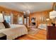 Spacious main bedroom with wood paneling, chandelier, brick fireplace and sitting area at 1068 Witherbee Rd, Moncks Corner, SC 29461
