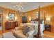 Comfortable main bedroom with chandelier, wood paneling, and large seating area at 1068 Witherbee Rd, Moncks Corner, SC 29461