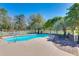 Inviting backyard pool featuring lounge chairs, complemented by lush landscaping and a classic white picket fence at 1068 Witherbee Rd, Moncks Corner, SC 29461