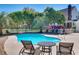 Backyard pool with lush landscaping, white picket fence, and patio furniture at 1068 Witherbee Rd, Moncks Corner, SC 29461