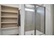 Modern bathroom showcasing a glass-enclosed shower with tiled walls, a convenient built-in shelving unit, and neutral colors at 114 Midmills Ln, Summerville, SC 29486