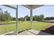 This patio looks out to the backyard with mature trees, a pond and green grass at 114 Midmills Ln, Summerville, SC 29486