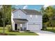 Charming two-story home with light blue siding, a front porch, a two car garage, and a well manicured lawn at 116 Moscato Ln, Summerville, SC 29485