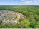 Stunning aerial view highlighting a residential area and a tranquil pond within a lush green forested landscape at 1160 Old Field Dr, Summerville, SC 29483