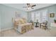 Light filled bedroom features colorful paisley bedding, plush carpet, and two sitting chairs for comfortable relaxation at 1160 Old Field Dr, Summerville, SC 29483