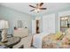 Bedroom features colorful patterned bedding, with a large dresser and bright lighting at 1160 Old Field Dr, Summerville, SC 29483