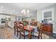 Open floor plan showcasing dining room with table, chairs, rug, with the kitchen and living area visible in background at 1160 Old Field Dr, Summerville, SC 29483