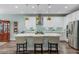 Bright kitchen features white cabinets, an island with seating, stainless steel appliances, and modern pendant lighting at 1160 Old Field Dr, Summerville, SC 29483