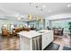 Open concept kitchen with island, stainless steel appliances, quartz countertops, seamlessly flowing to dining and living areas at 1160 Old Field Dr, Summerville, SC 29483