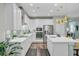 A modern kitchen featuring white cabinets, quartz countertops, stainless steel appliances, and a kitchen island at 1160 Old Field Dr, Summerville, SC 29483