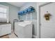 Bright and functional laundry room with modern appliances and storage shelves at 1160 Old Field Dr, Summerville, SC 29483