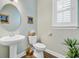 Powder room featuring wood flooring, pedestal sink, decorative art, and ample natural light at 1160 Old Field Dr, Summerville, SC 29483