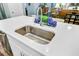 Kitchen island sink with stainless steel faucet, white quartz countertops, and blue decorative accents at 1160 Old Field Dr, Summerville, SC 29483