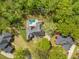 Aerial view of a home with a private backyard pool and deck, surrounded by mature trees at 118 Elery Ter, Summerville, SC 29485