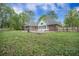 Expansive backyard with well-maintained lawn, mature trees, and a pool, perfect for outdoor enjoyment and relaxation at 118 Elery Ter, Summerville, SC 29485