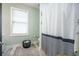 Bathroom with patterned shower curtain, window, and decorative basket, offering style and function at 118 Elery Ter, Summerville, SC 29485