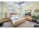 Bright bedroom with a wooden bed frame, matching nightstands, dresser, and a ceiling fan at 118 Elery Ter, Summerville, SC 29485
