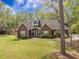 Charming brick home featuring manicured landscaping, arched windows, and a welcoming front porch at 118 Elery Ter, Summerville, SC 29485