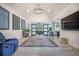 Bright living room featuring vaulted ceilings, a statement chandelier, and sliding barn doors at 118 Elery Ter, Summerville, SC 29485
