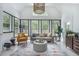 Bright living room with large windows, modern furnishings, and vaulted ceiling at 118 Elery Ter, Summerville, SC 29485