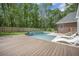 Outdoor pool with waterfall feature and lounge chairs, surrounded by lush green lawn and mature trees at 118 Elery Ter, Summerville, SC 29485