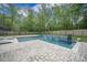 Outdoor pool area showcasing brick pavers, lounge chairs, and modern waterfall feature surrounded by lush greenery at 118 Elery Ter, Summerville, SC 29485