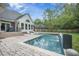 Backyard pool featuring a waterfall, lounge chairs, and an expansive patio perfect for relaxation and entertaining at 118 Elery Ter, Summerville, SC 29485
