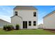 Backyard featuring a white two-story home and green grass at 118 Lilac Grove Way, Summerville, SC 29486