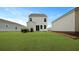 Backyard featuring a white two-story home and a lawn at 118 Lilac Grove Way, Summerville, SC 29486