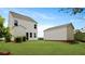 Backyard featuring a white two-story home, green grass, and landscaping at 118 Lilac Grove Way, Summerville, SC 29486