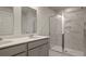 Elegant bathroom featuring a double vanity, framed mirrors, and a tiled shower at 118 Lilac Grove Way, Summerville, SC 29486