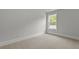 Cozy bedroom featuring neutral carpet, a window providing natural light and base trim at 118 Lilac Grove Way, Summerville, SC 29486
