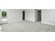Large bedroom featuring carpet, trim, multiple doors and windows overlooking the yard at 118 Lilac Grove Way, Summerville, SC 29486