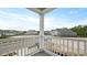 View of the neighborhood from the covered patio with white railings and gray floor at 118 Lilac Grove Way, Summerville, SC 29486