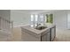 Open-concept kitchen featuring a large island with a sink, stainless steel appliances, and plenty of natural light at 118 Lilac Grove Way, Summerville, SC 29486