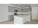 Elegant kitchen showcasing gray cabinetry, stainless steel appliances, a subway tile backsplash, and a spacious island at 118 Lilac Grove Way, Summerville, SC 29486
