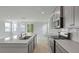 Modern kitchen with gray cabinets, stainless steel appliances, and a large island overlooking the living area at 118 Lilac Grove Way, Summerville, SC 29486
