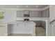 Modern kitchen featuring gray cabinets, stainless steel appliances, white countertops, and a large center island at 118 Lilac Grove Way, Summerville, SC 29486
