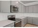 Well-appointed kitchen with gray cabinets, stainless steel appliances, and a bright white subway tile backsplash at 118 Lilac Grove Way, Summerville, SC 29486