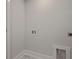 Laundry room with washer hookups, white trim, neutral walls, and marble flooring at 118 Lilac Grove Way, Summerville, SC 29486