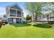Spacious backyard with lush green grass and trampoline at 1188 Quick Rabbit Loop, Charleston, SC 29414
