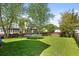 Large backyard featuring a green lawn, a trampoline, and a wooden fence at 1188 Quick Rabbit Loop, Charleston, SC 29414