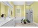 Bright bathroom with a tub, shower, double sink vanity, and a window offering natural light at 1188 Quick Rabbit Loop, Charleston, SC 29414