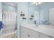 Bright bathroom with a white vanity, shower, and ample natural light at 1188 Quick Rabbit Loop, Charleston, SC 29414