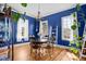 Charming dining room with round table set, hardwood floors, and stylish blue walls at 1188 Quick Rabbit Loop, Charleston, SC 29414
